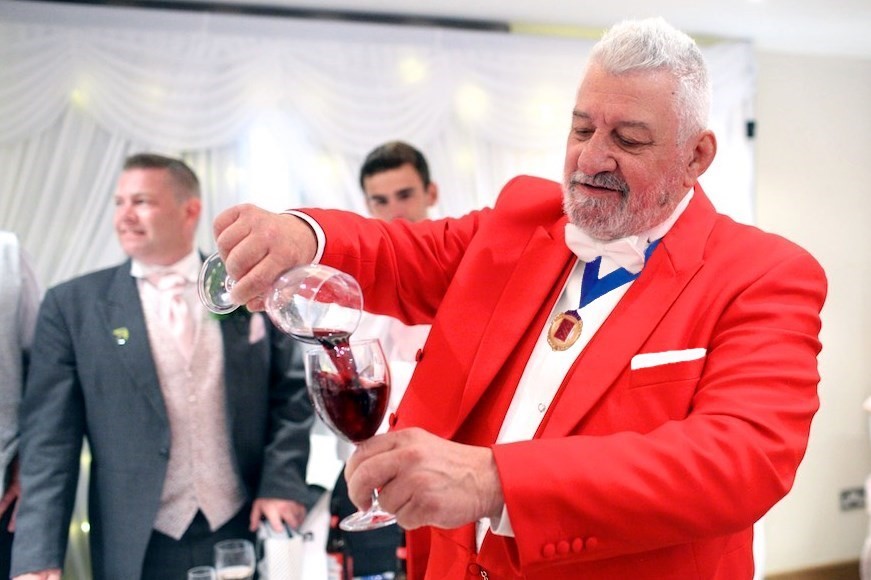 Toastmaster pouring wine at wedding